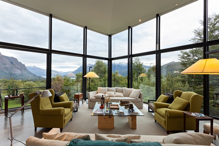 Modern living room with large windows and mountain view