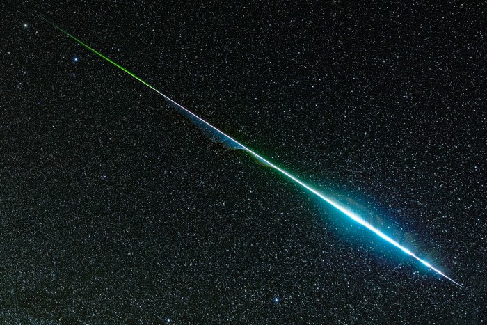 Meteor streaking across a starry night sky