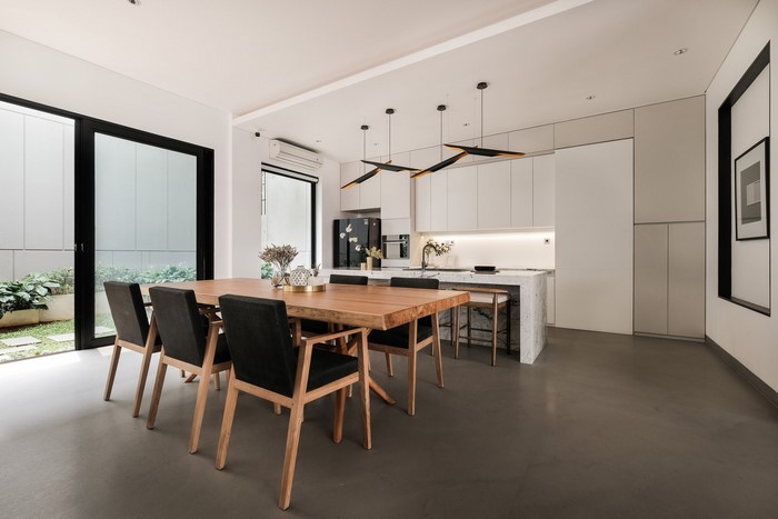 Modern dining room and kitchen with wooden table and chairs