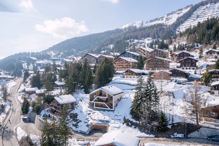 Modern houses in a snowy Swiss mountain village
