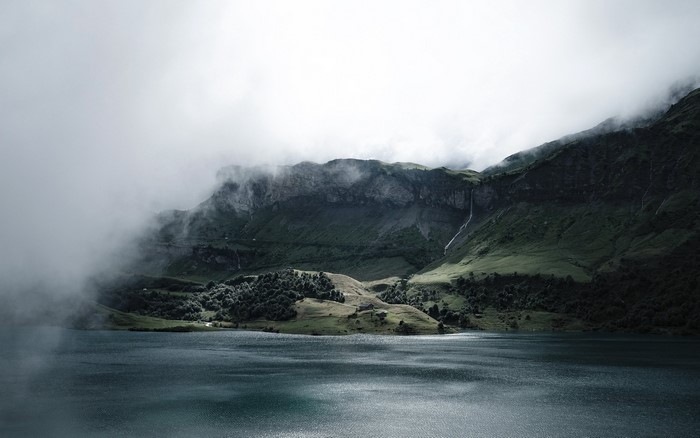 Misty mountains and lake landscape