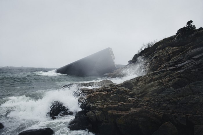 Architecture on a rocky coast with waves crashing