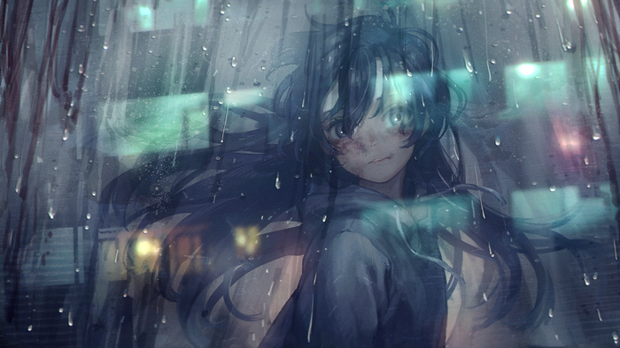 Girl in sweatshirt looking through a rainy window