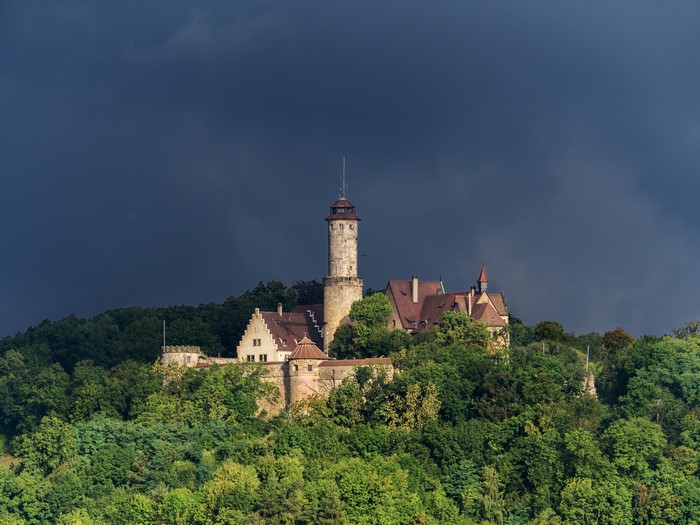 Castle on a hill under dark sky