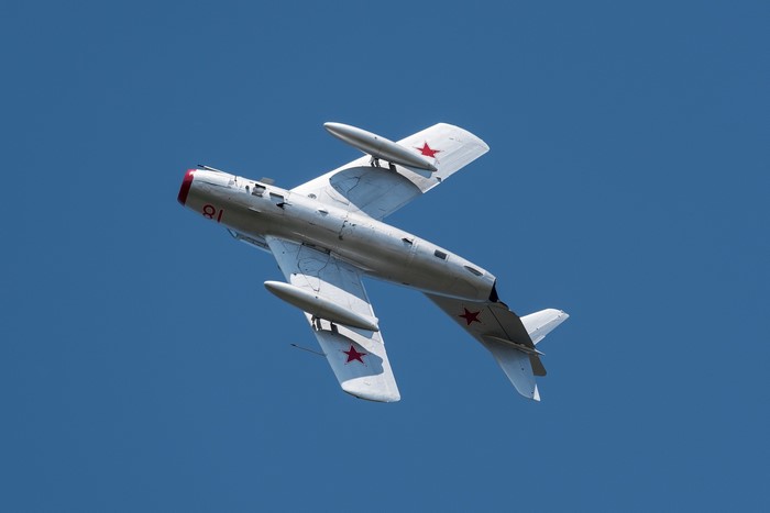 Silver Soviet MiG-17 Fighter Jet in Flight