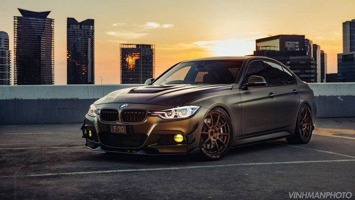 BMW 3 Series sports car in a city at sunset