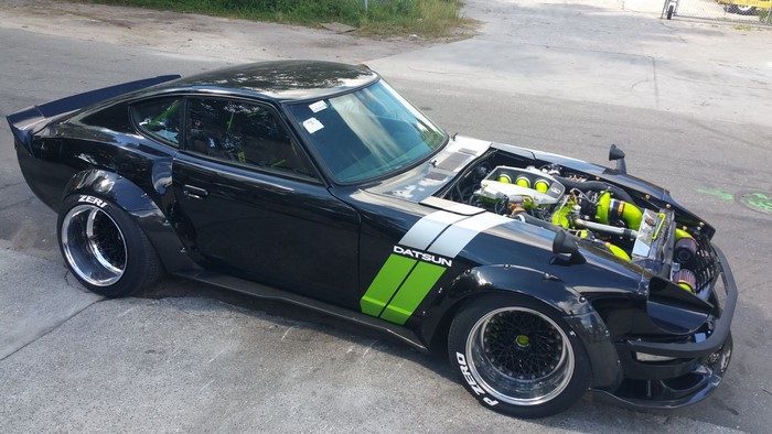 Black Datsun 240Z with bolt-on fender flares and custom engine