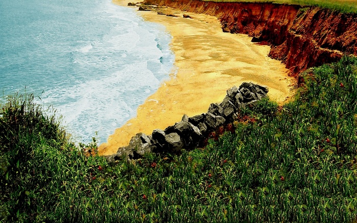 Coastal cliff overlooking a sandy beach and ocean