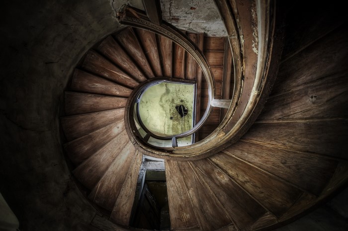 Abandoned spiral staircase in a derelict building