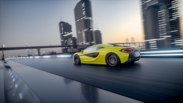 Yellow McLaren 570S driving on a futuristic city road