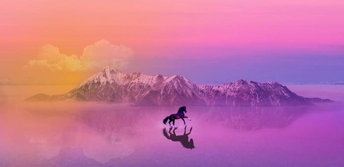 Horse running in front of mountains at sunset with reflection