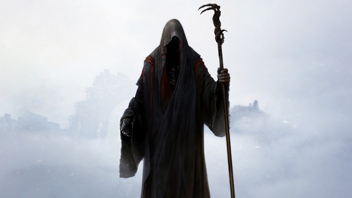 Figure in a dark hooded robe holding a staff