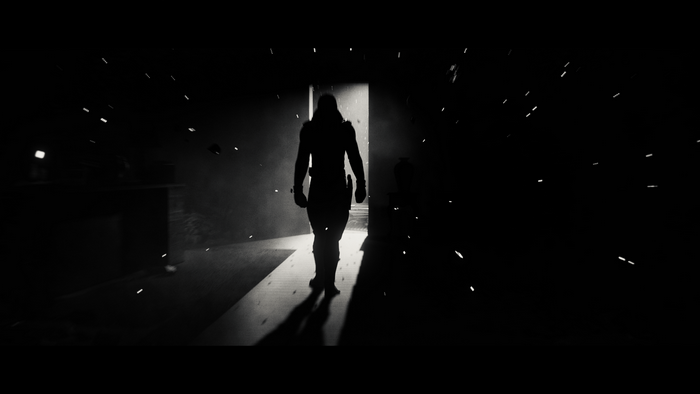 Silhouette of a person walking through a doorway