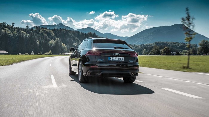 Black ABT Audi Q8 driving on a mountain road