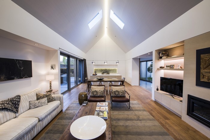 Modern living room with vaulted ceiling and kitchen