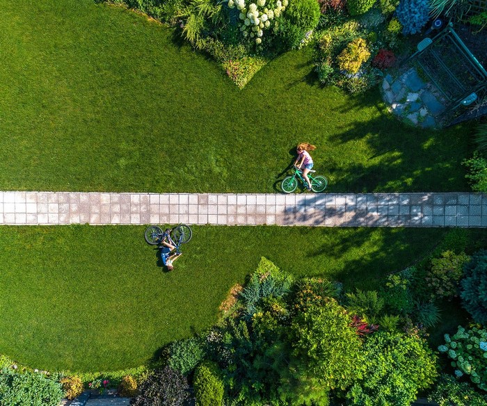 Aerial view of children with bicycles in a garden