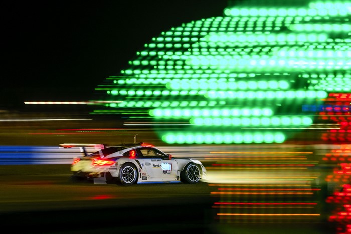 Porsche 911 RSR racing at night with motion blur