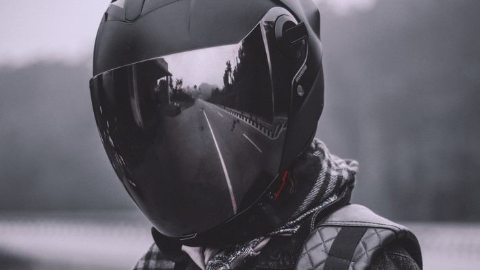 Biker wearing a helmet with road reflection