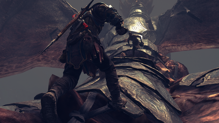 Kratos from God of War fighting a giant