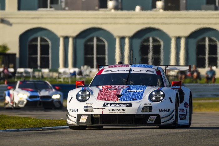 Porsche 911 RSR and BMW M8 GTE race cars on track