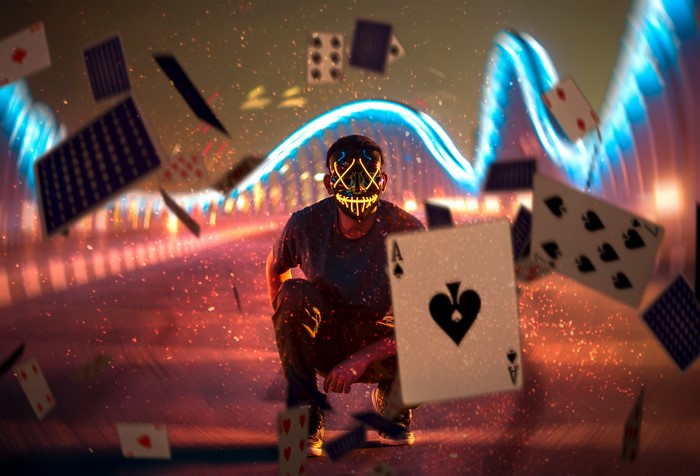 Man in Neon Mask with Floating Cards