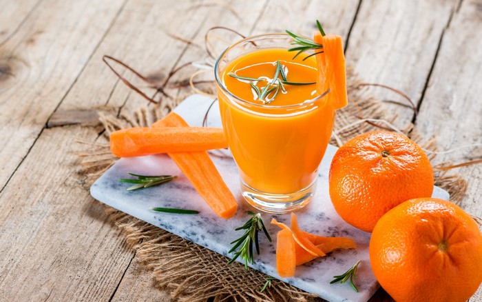 Carrot and orange juice with rosemary and carrots