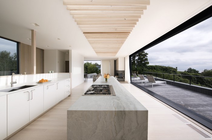 Modern kitchen with island and large sliding glass door