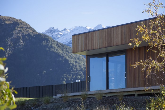 Modern house with large windows and snowy mountains
