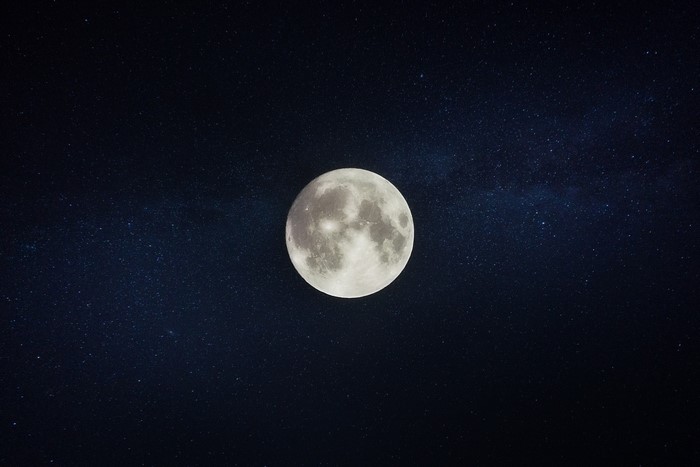 Full moon in a starry night sky