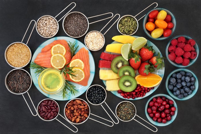 Healthy food assortment with salmon, fruits, seeds, and beans