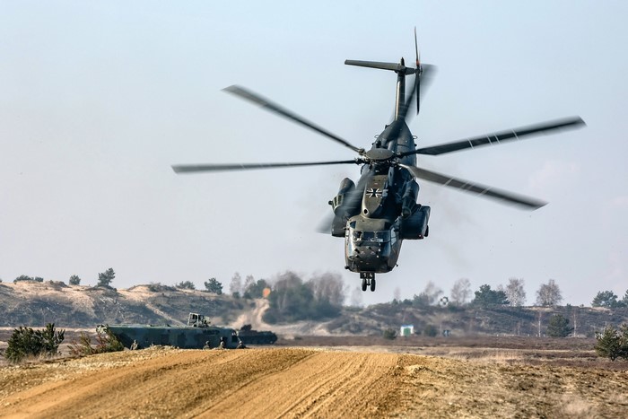 German Army helicopter in flight over a training ground