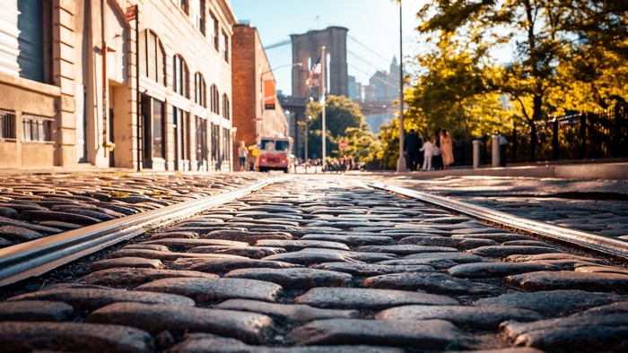 Cobblestone street with Brooklyn Bridge in New York City