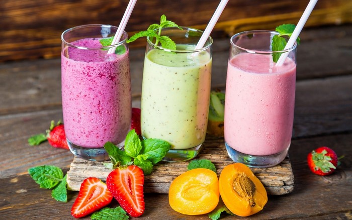 Three colorful fruit smoothies with strawberries and apricots