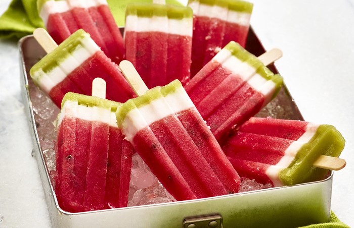 Watermelon and kiwi popsicles in a metal tray