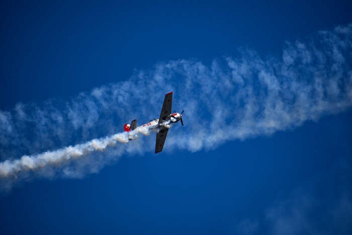 Airplane performing aerobatics with smoke trail