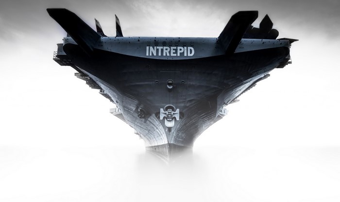 USS Intrepid aircraft carrier emerging from fog