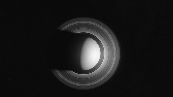 Saturn and its rings casting a shadow