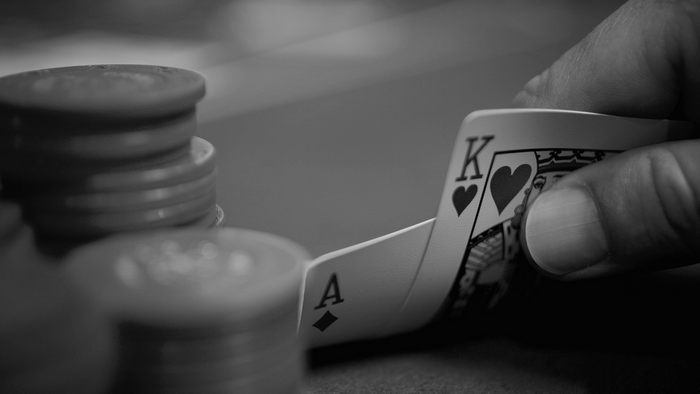Ace and King of Hearts playing cards with poker chips