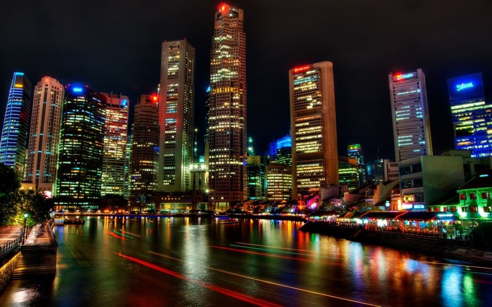 Singapore skyline at night with river and light trails