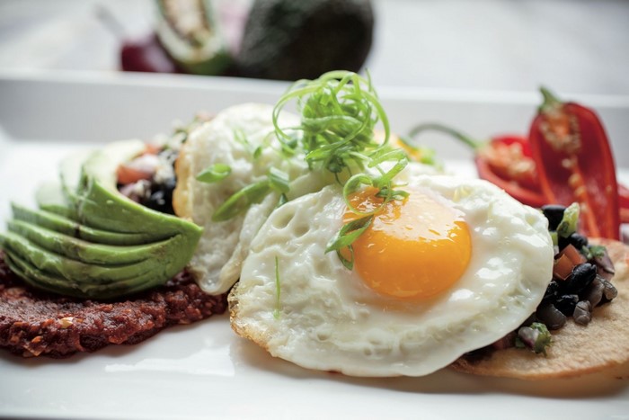Fried eggs with avocado and chili