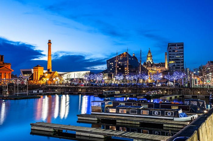 Liverpool cityscape at dusk with waterfront and boats