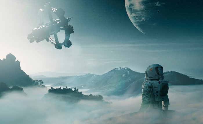Astronaut looking at a space station and a planet