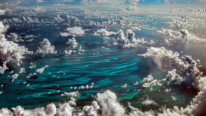 Aerial view of turquoise water and clouds