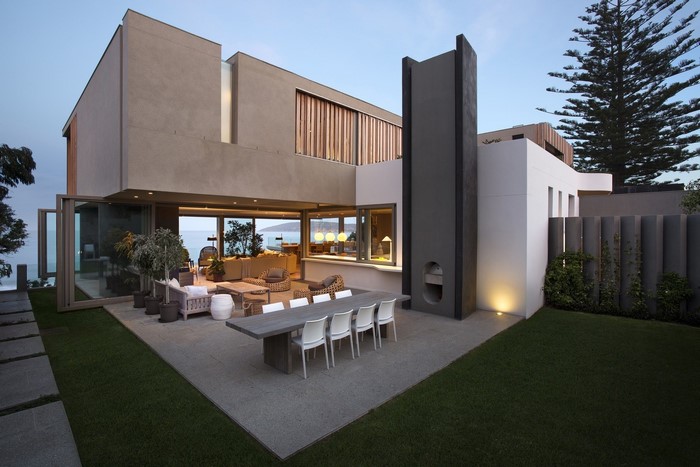 Modern house with outdoor dining area and ocean view