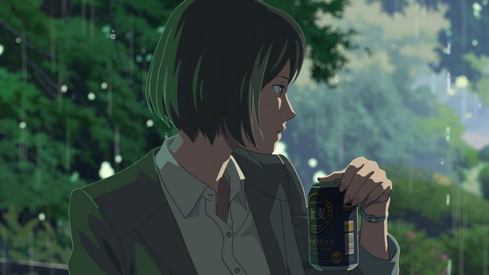 Woman holding a beer can in the rain