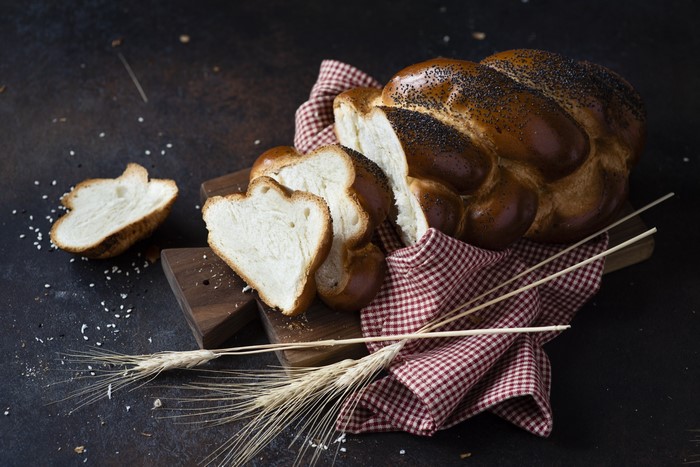 Braided challah bread with poppy seeds and wheat stalks