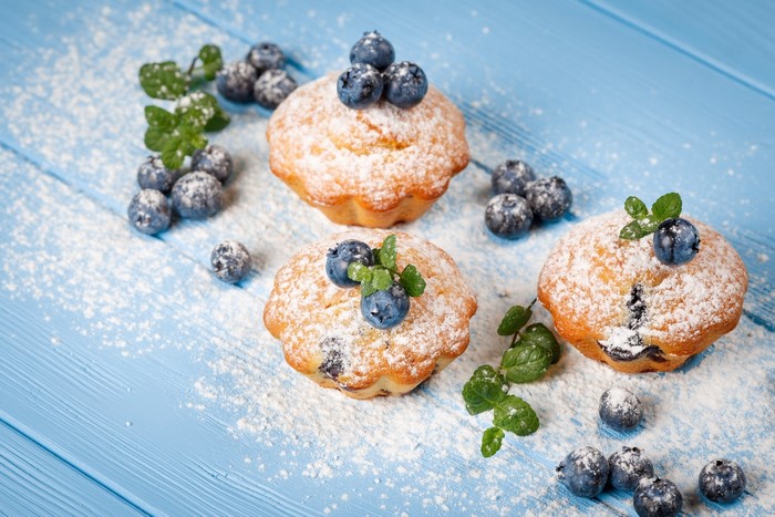 Blueberry muffins with powdered sugar and mint