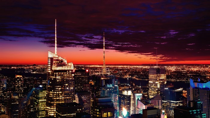 New York City skyline at dusk with sunset and city lights