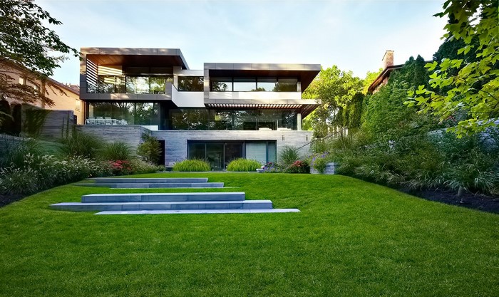 Modern house with a manicured lawn and stone steps