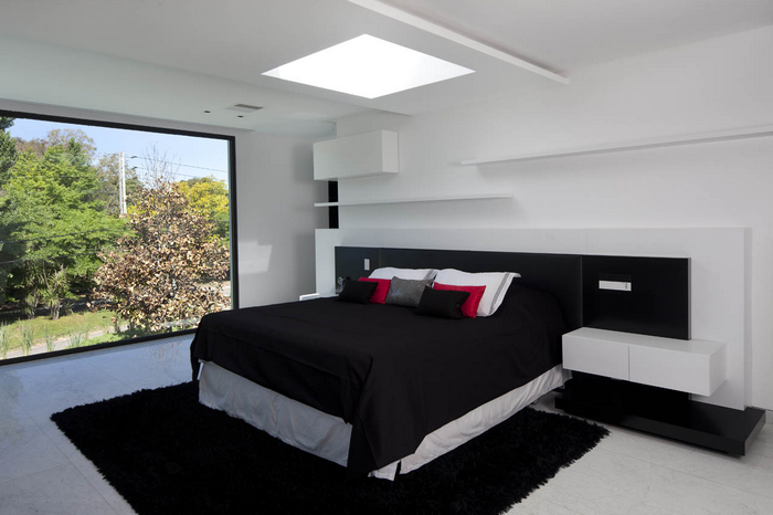 Modern bedroom with large window and black bed